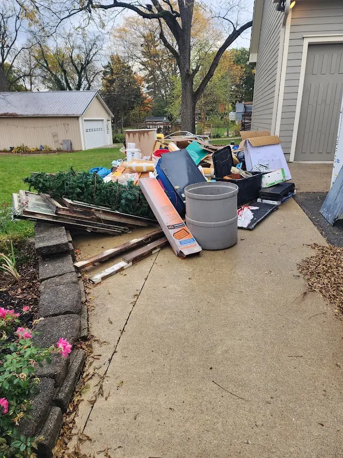 Dumpster being loaded with debris for Estate Cleanout Dumpster Rental in Juniper Canyon